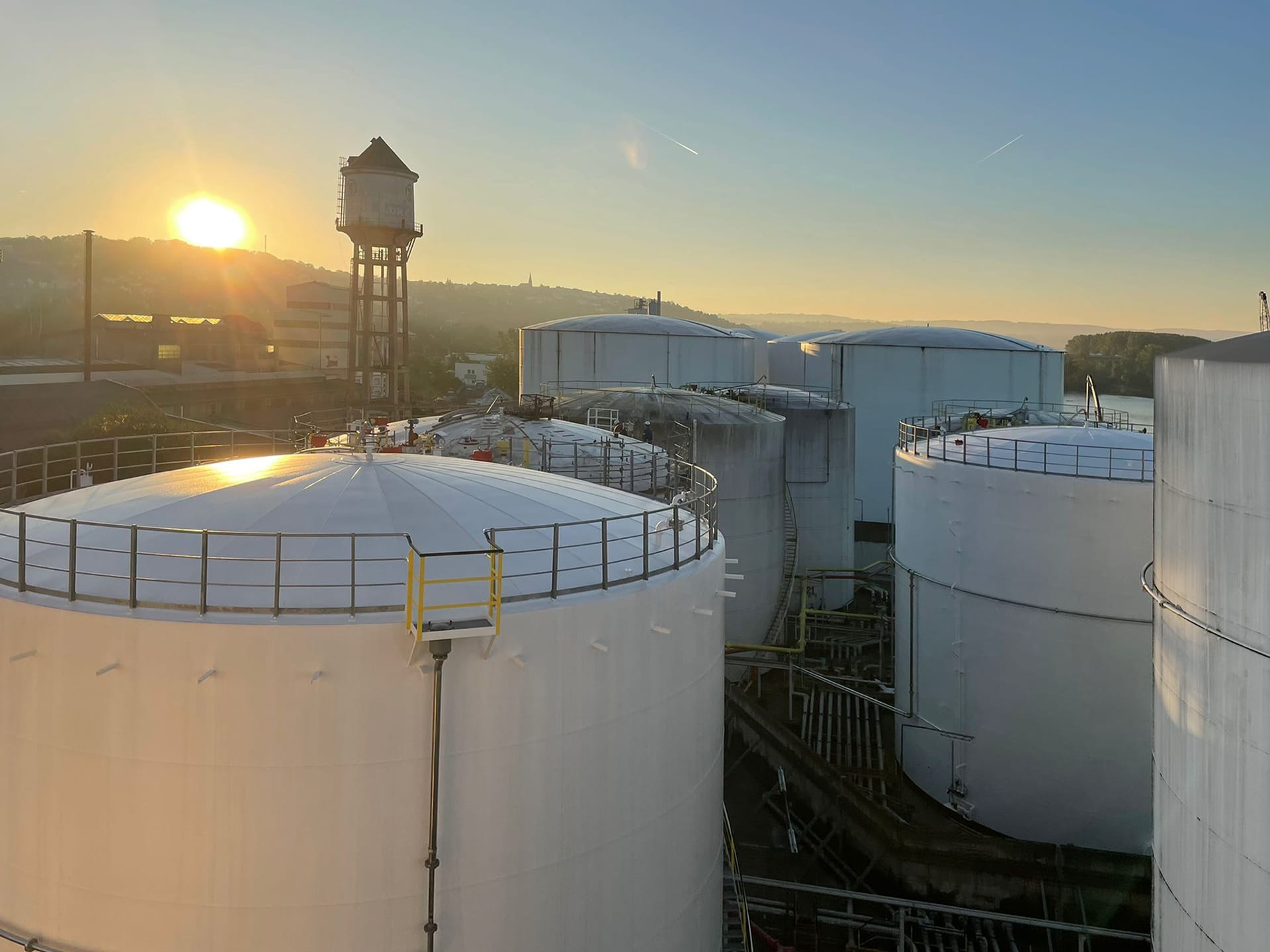 Industrielles Tanklager bei Sonnenaufgang – Rotan Anlagenbau für Lagerung von Flüssigkeiten in großvolumigen Tanks